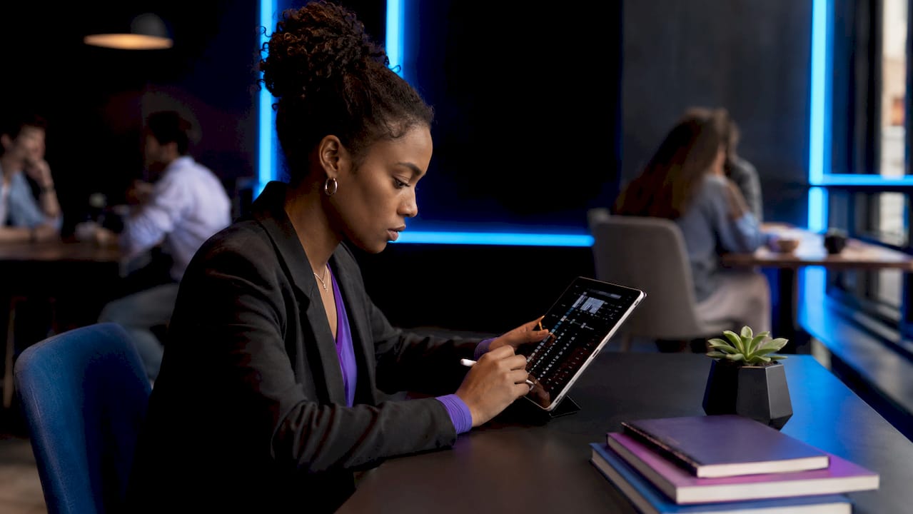 Female trader analyzing cryptocurrency data at home desk