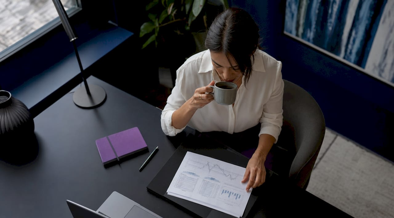 Financial engineer working at office desk in morning light